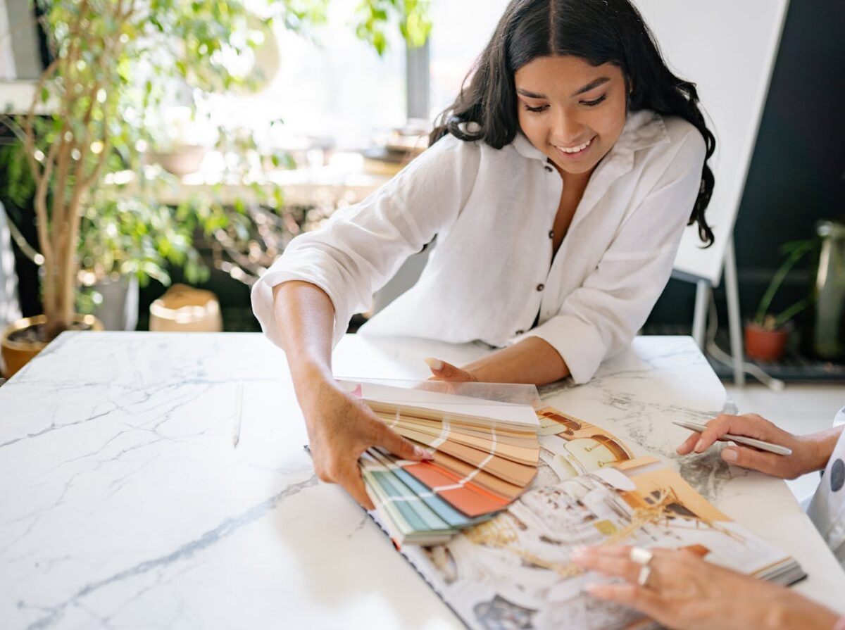 woman-holding-a-palette-with-color-samples-and-smiling